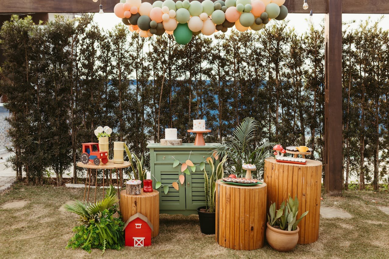 brand-02 Charming outdoor party setup featuring wooden decor and colorful balloons.